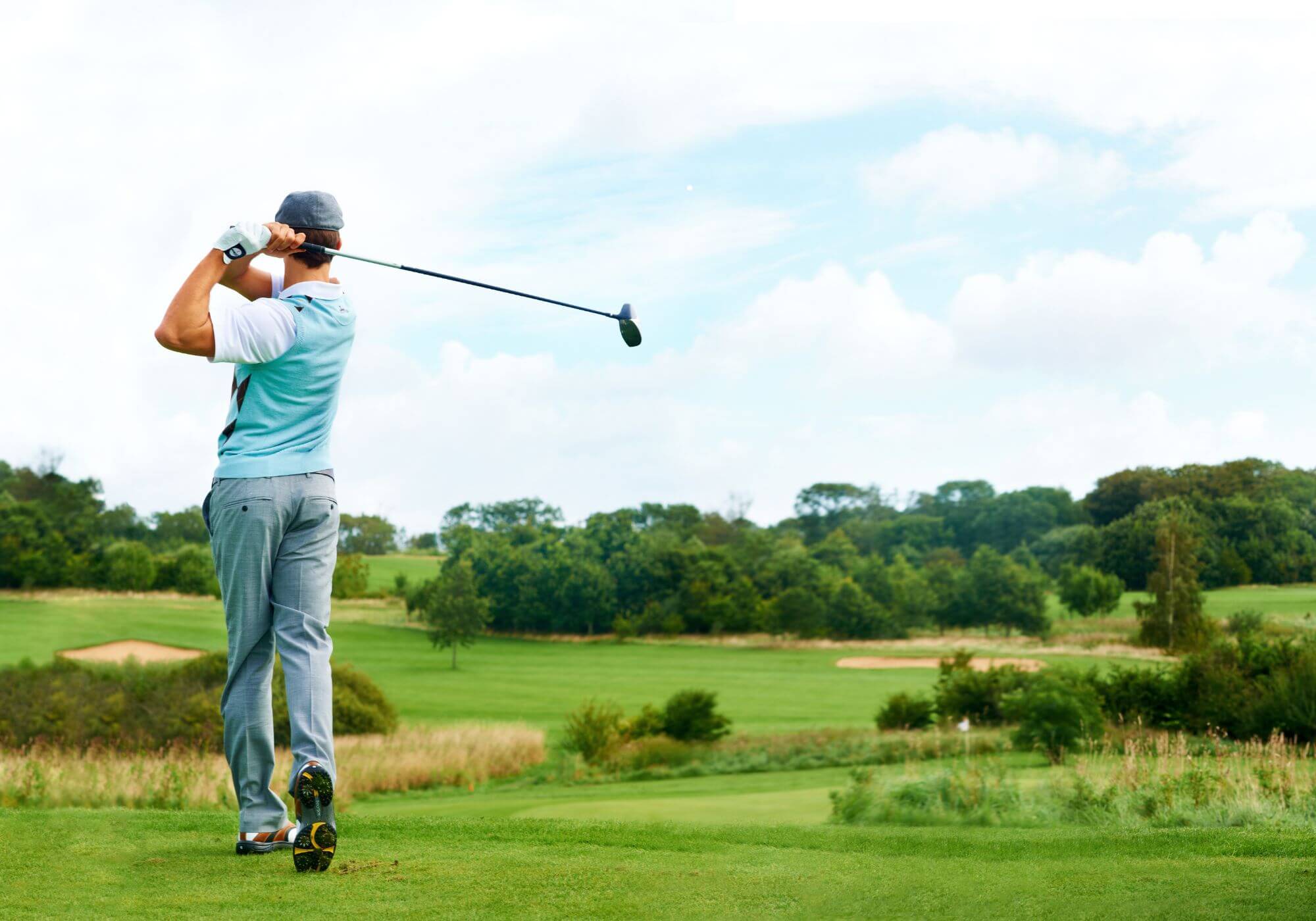 Golf Ball Below Feet: The Setup And Swing Changes You Need