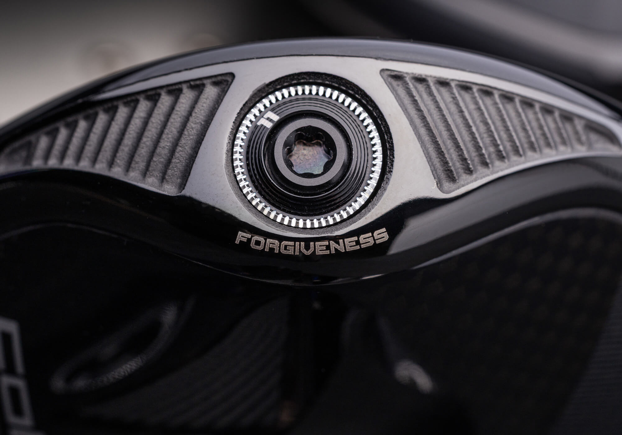 A closeup of the "forgiveness" weight port on the COBRA OPTM MAX-K Driver