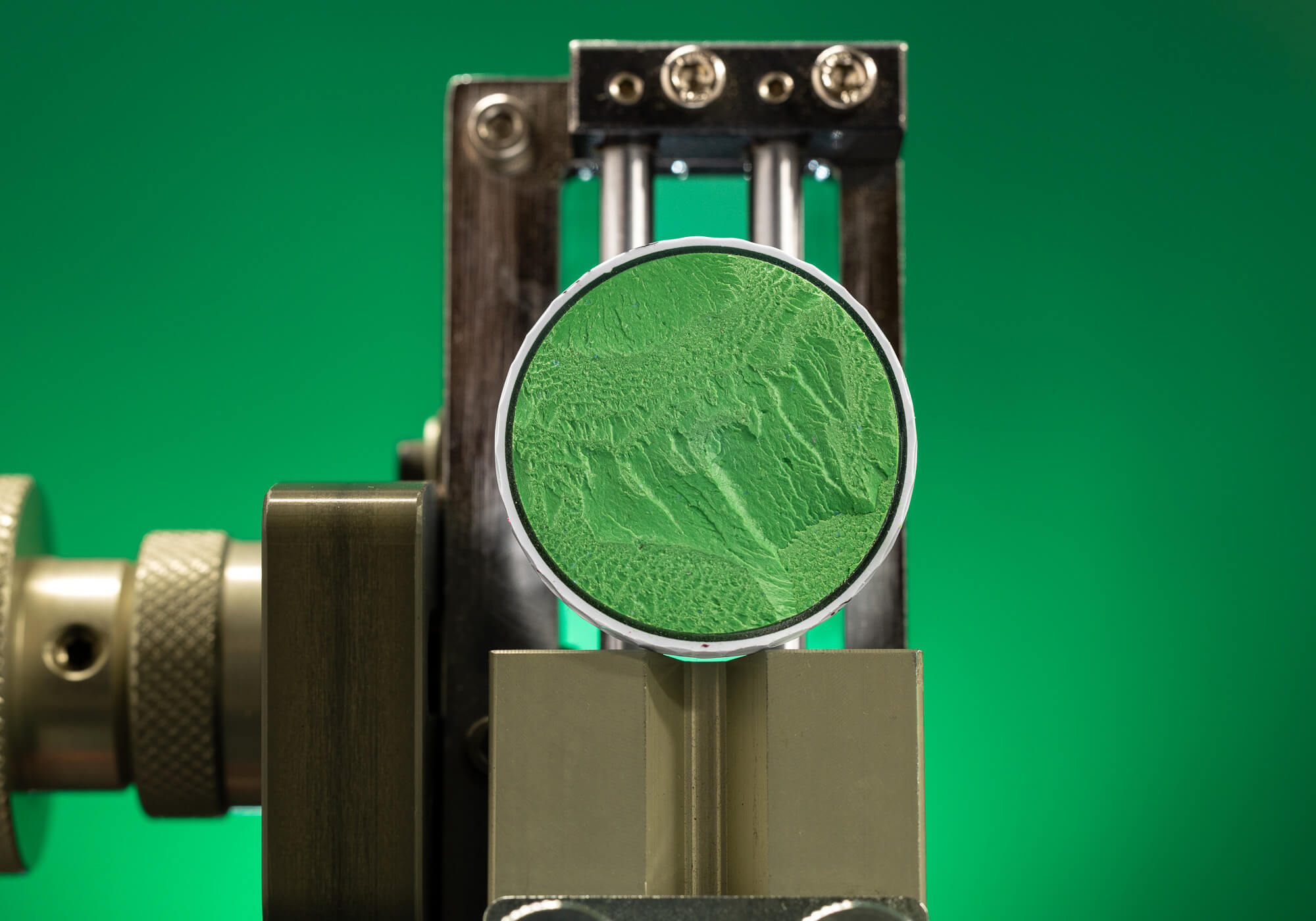 The core of a Titleist AVX golf ball against an illuminated green background