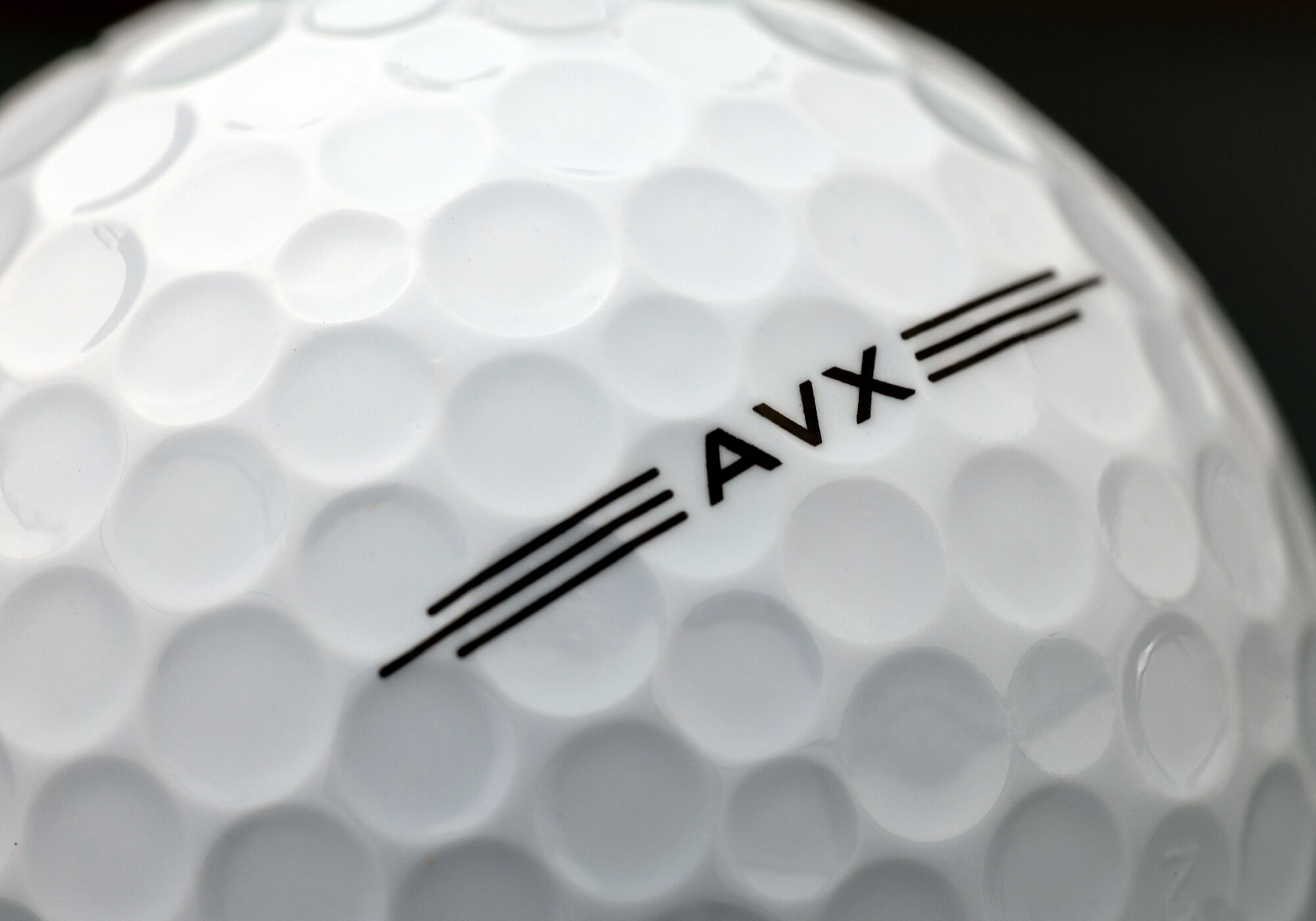 A close-up of a Titleist AVX golf ball
