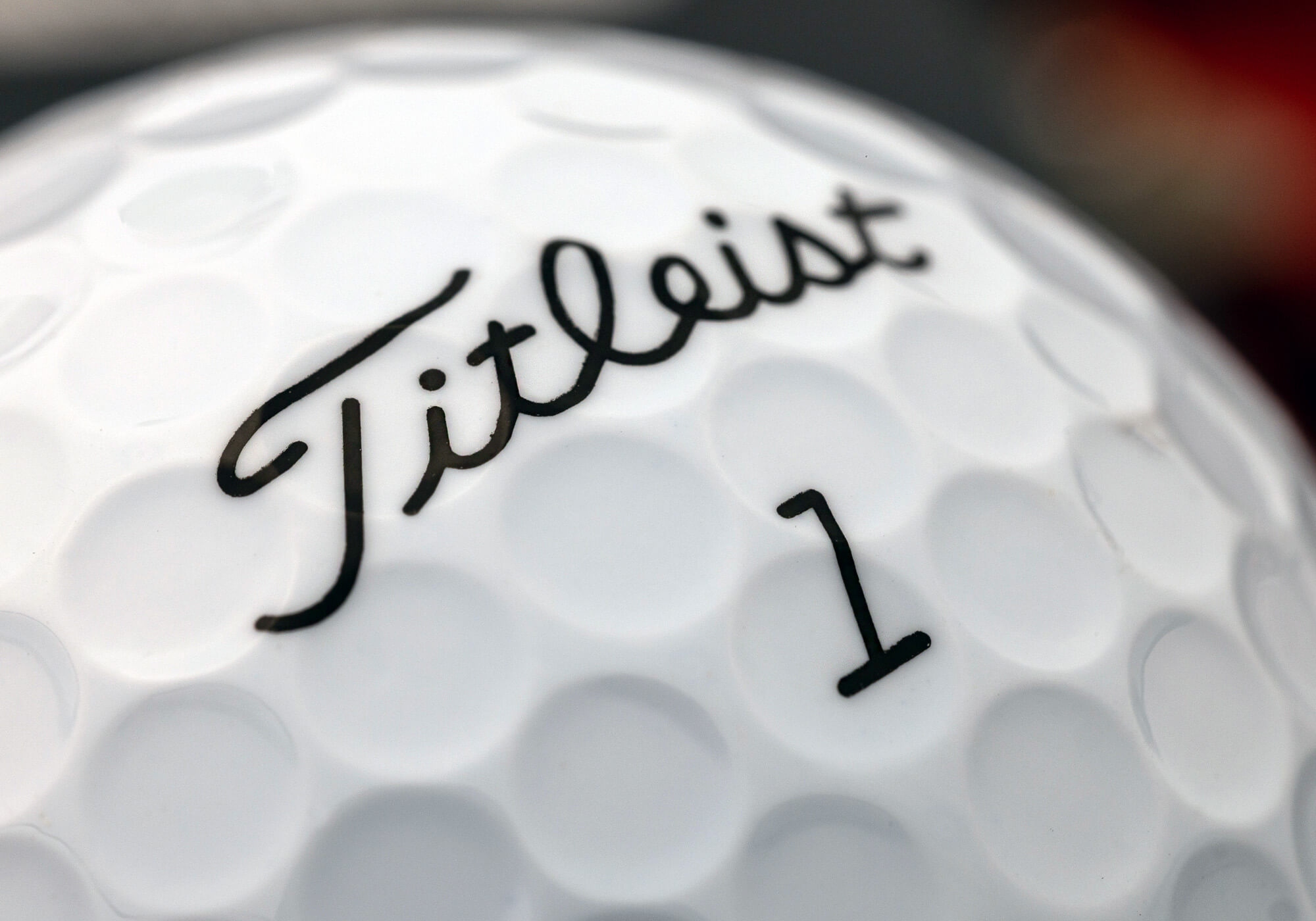 A close up of the logo on a Titleist AVX golf ball