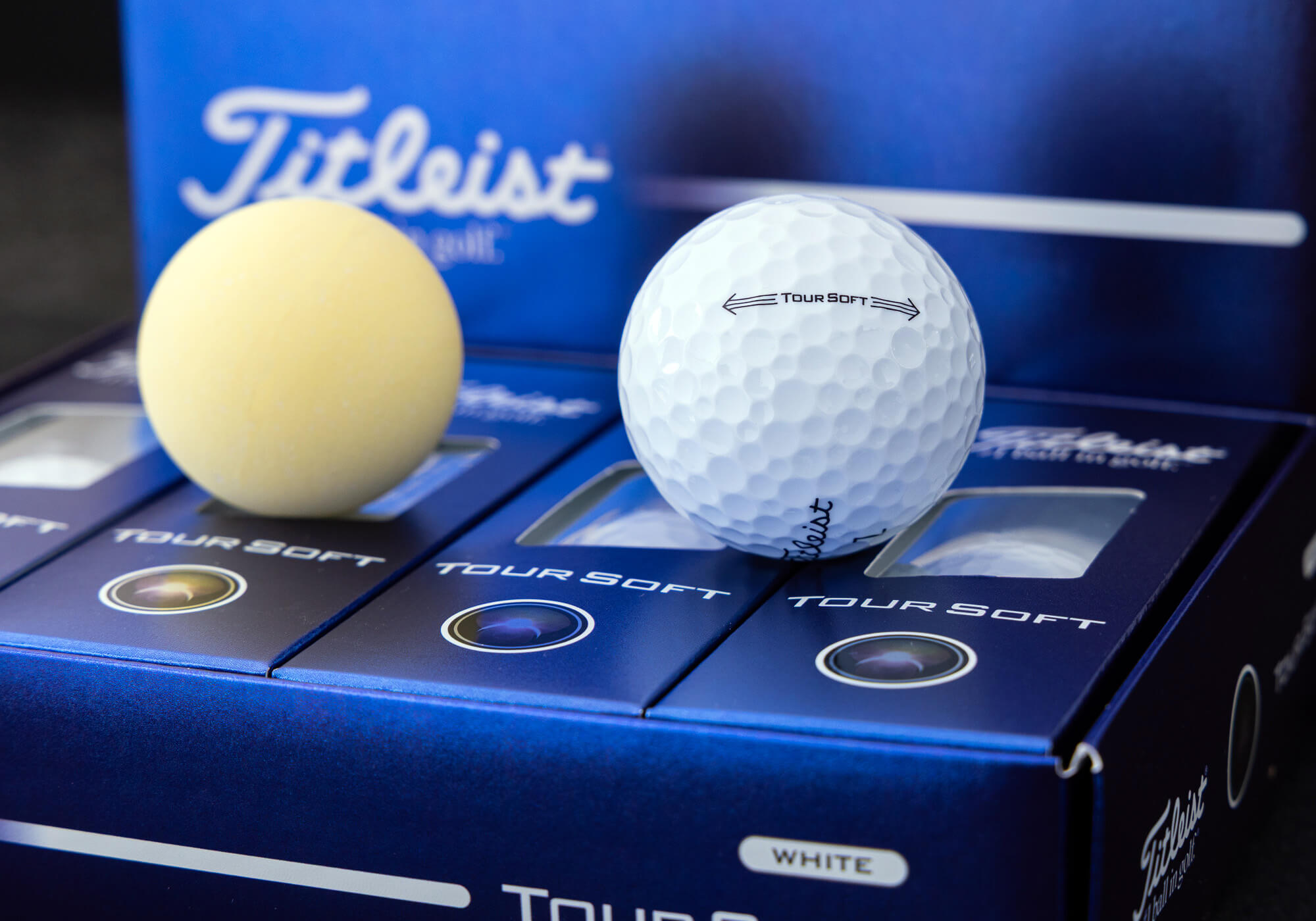 A Titleist Tour Soft Golf Top along with a full core supported in a case