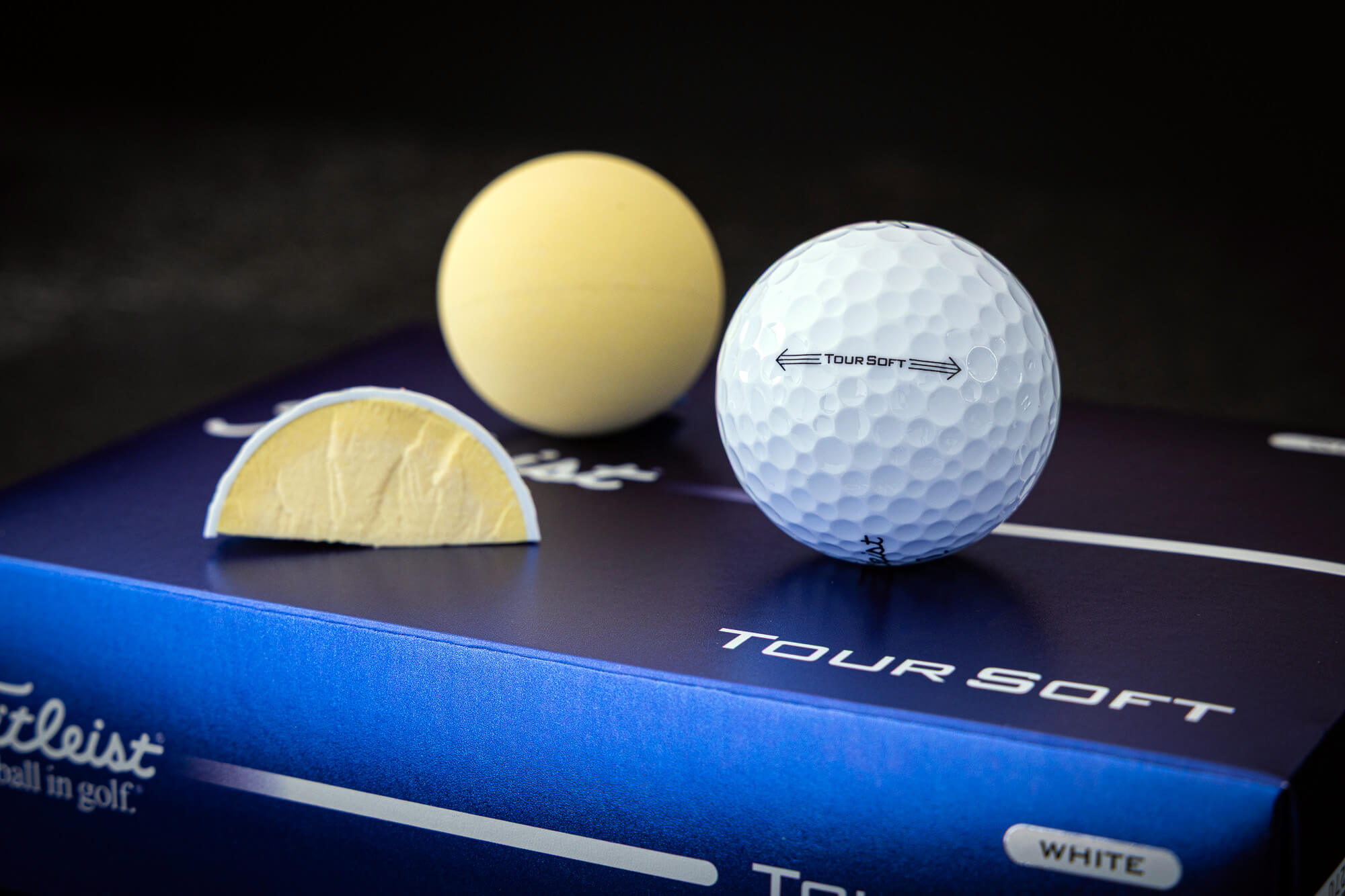 Titleist Tour Soft golf top along with a full core and cutouts to show construction.