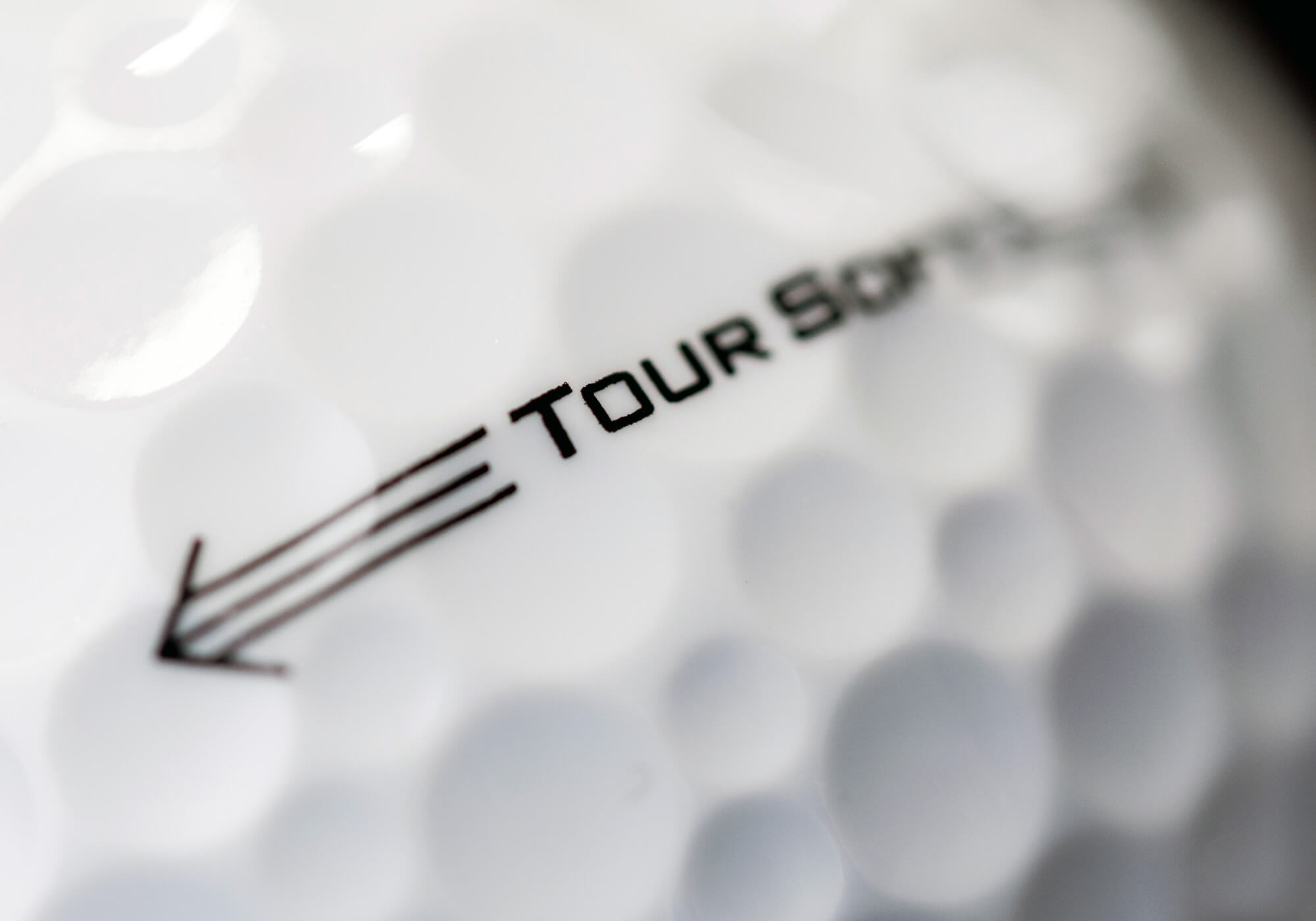 A close-up of the side knob on a soft Titleist Tour golf ball