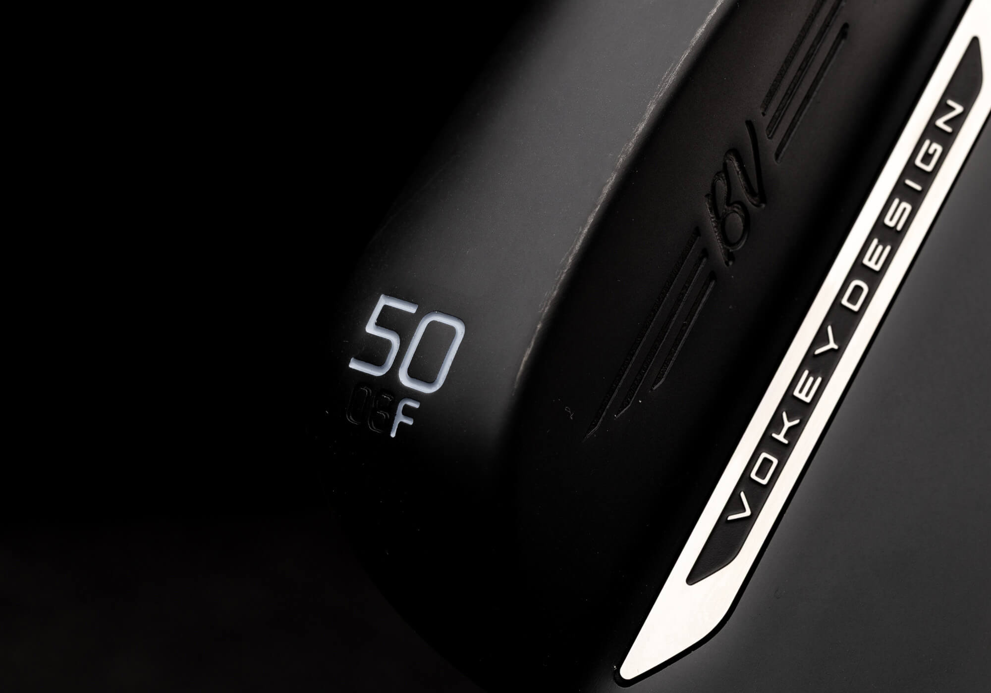 A closeup of a Jet Black Vokey SM11 wedge